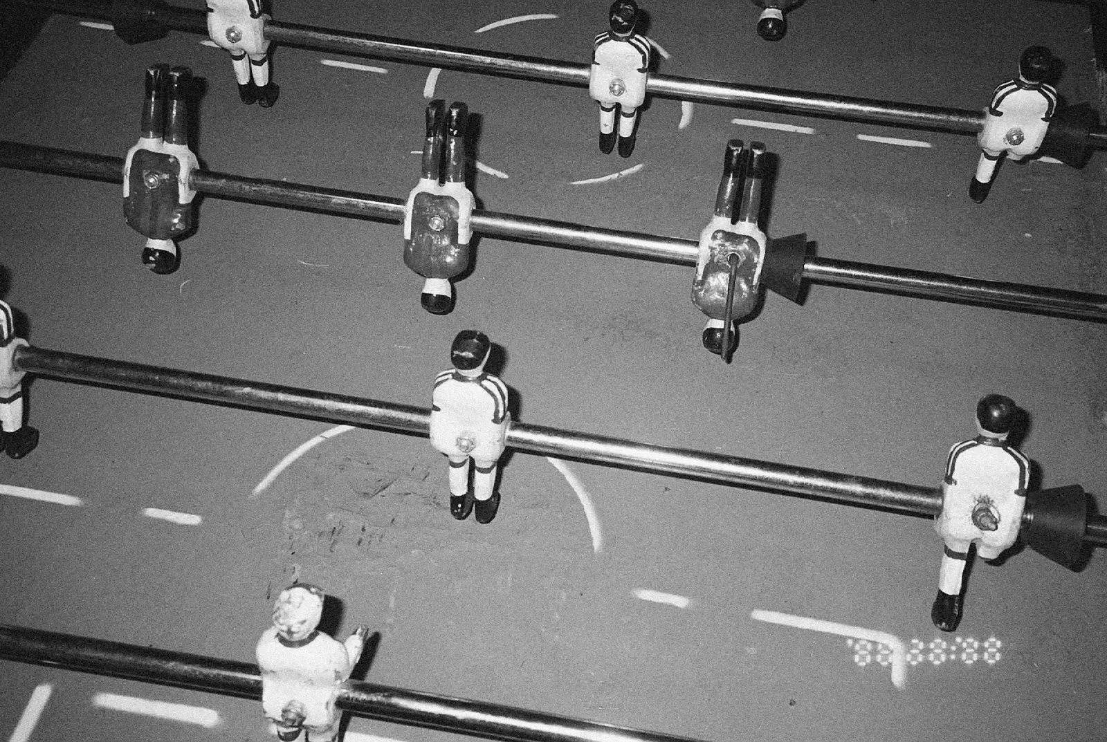 People gathered around a foosball table in a collaborative workspace